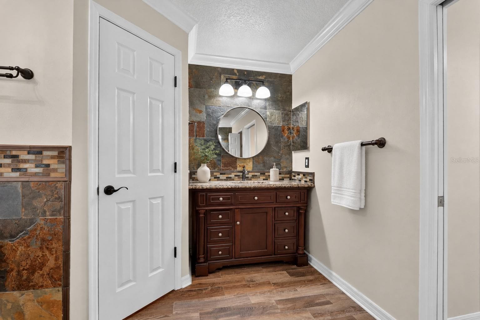 Primary bathroom vanity and adjoining shower area. - 2109 WEMBLEY PL, OVIEDO