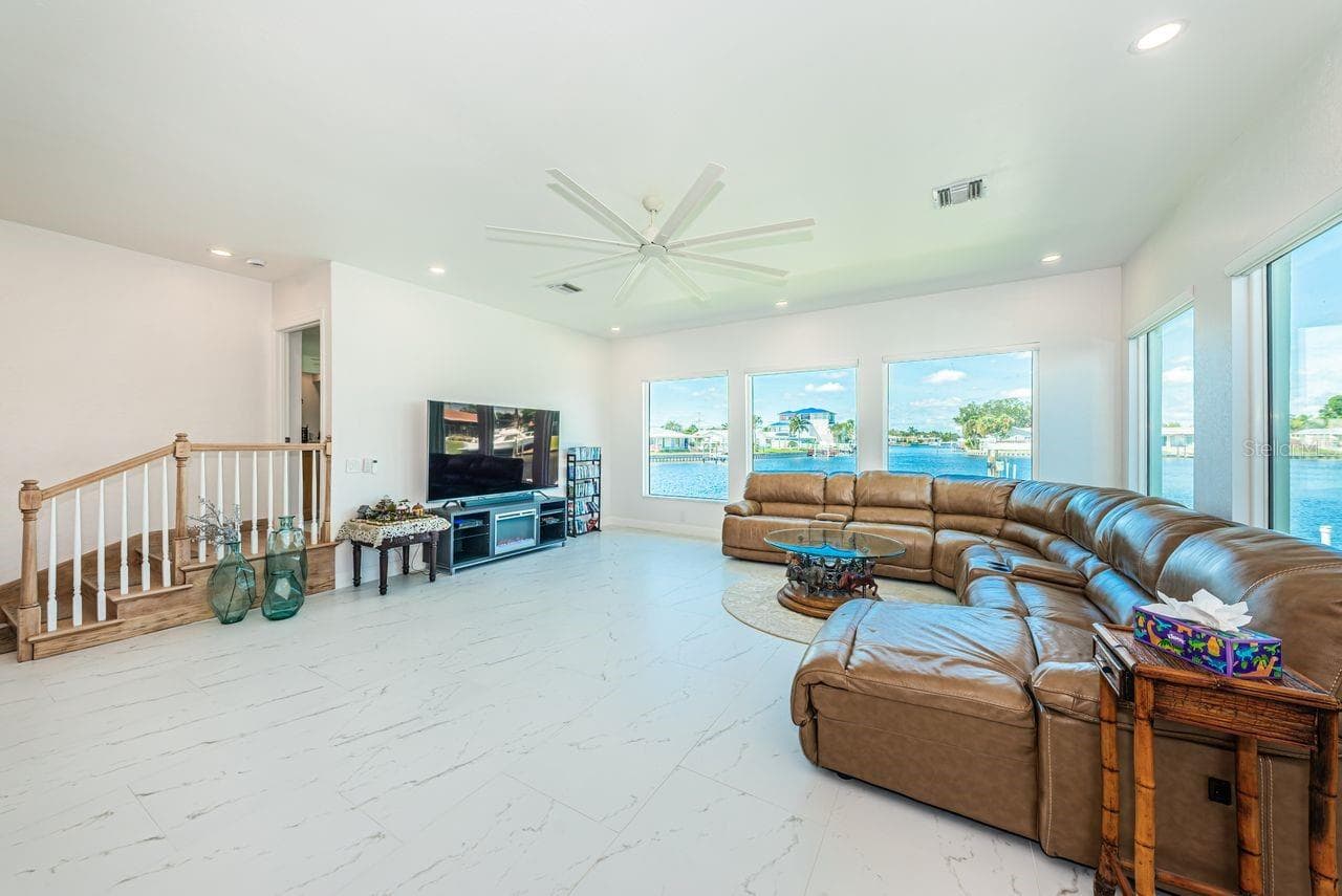 Five big picture windows allow you to enjoy the water view. 3 small steps lead to primary bedroom. - 4280 13TH LN NE, ST PETERSBURG