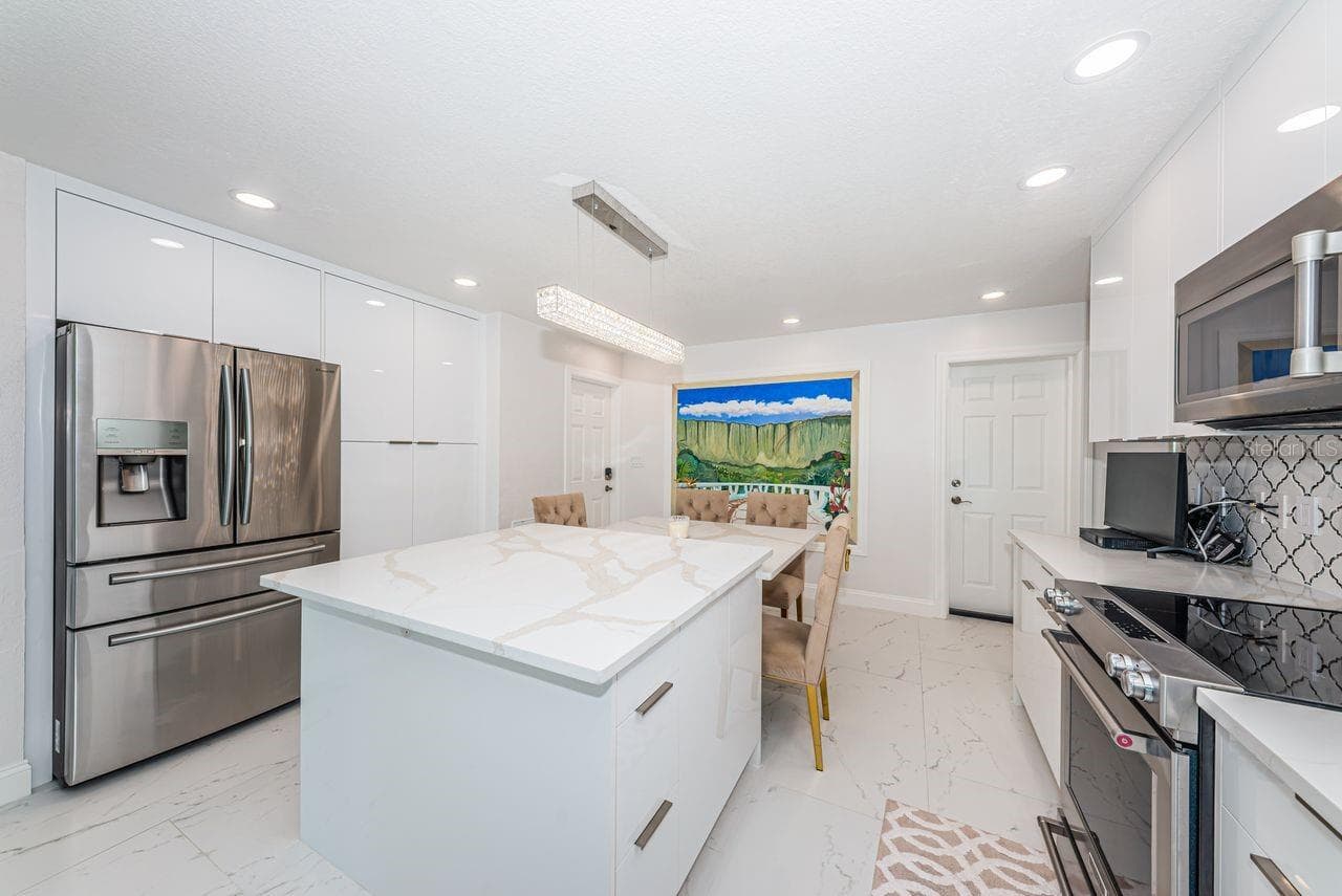 Beautiful quartz island with deep soft close drawers and charging outlets - 4280 13TH LN NE, ST PETERSBURG