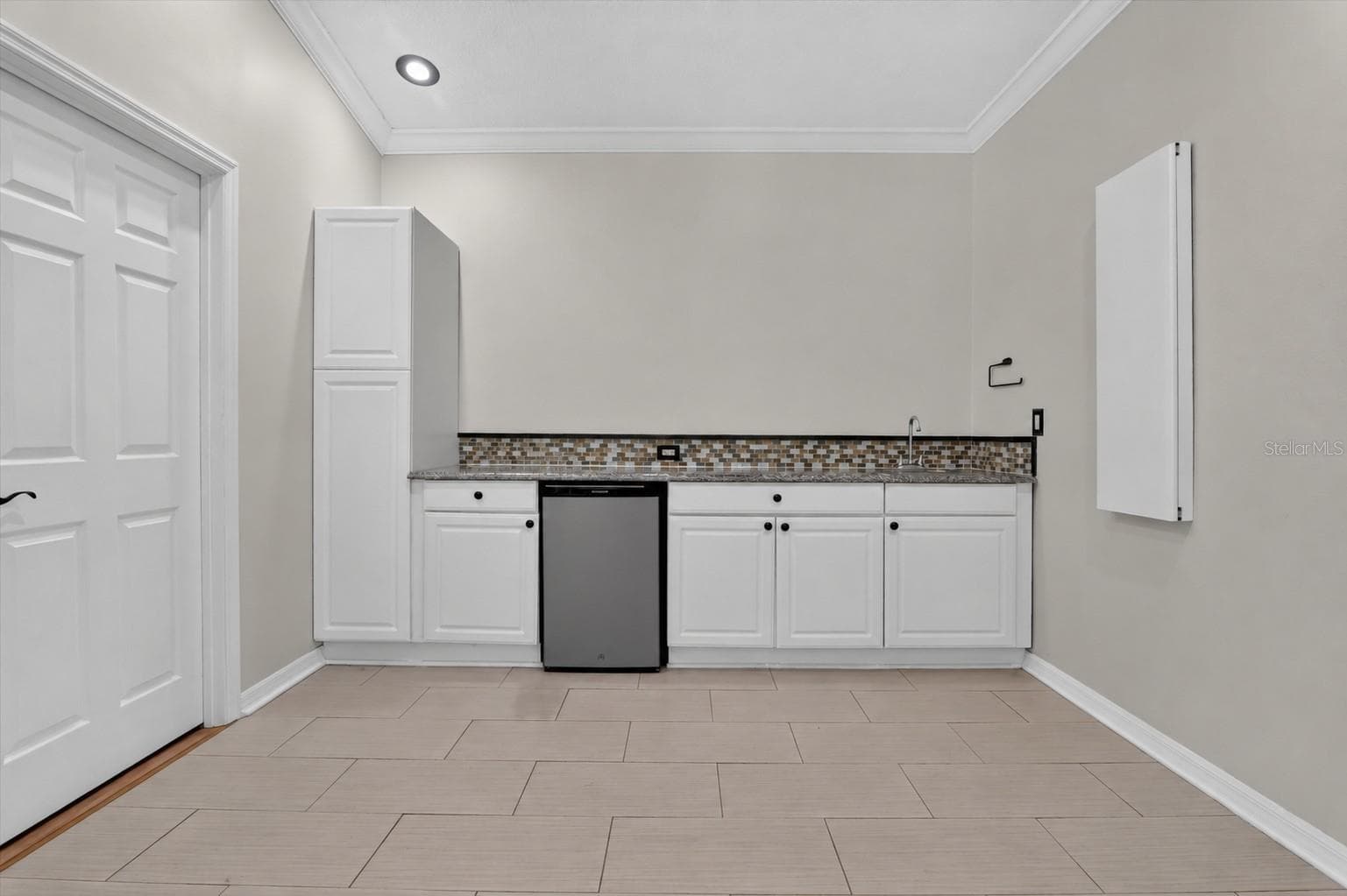 Not staged: Bonus-room wet bar area shown without furniture. - 2109 WEMBLEY PL, OVIEDO