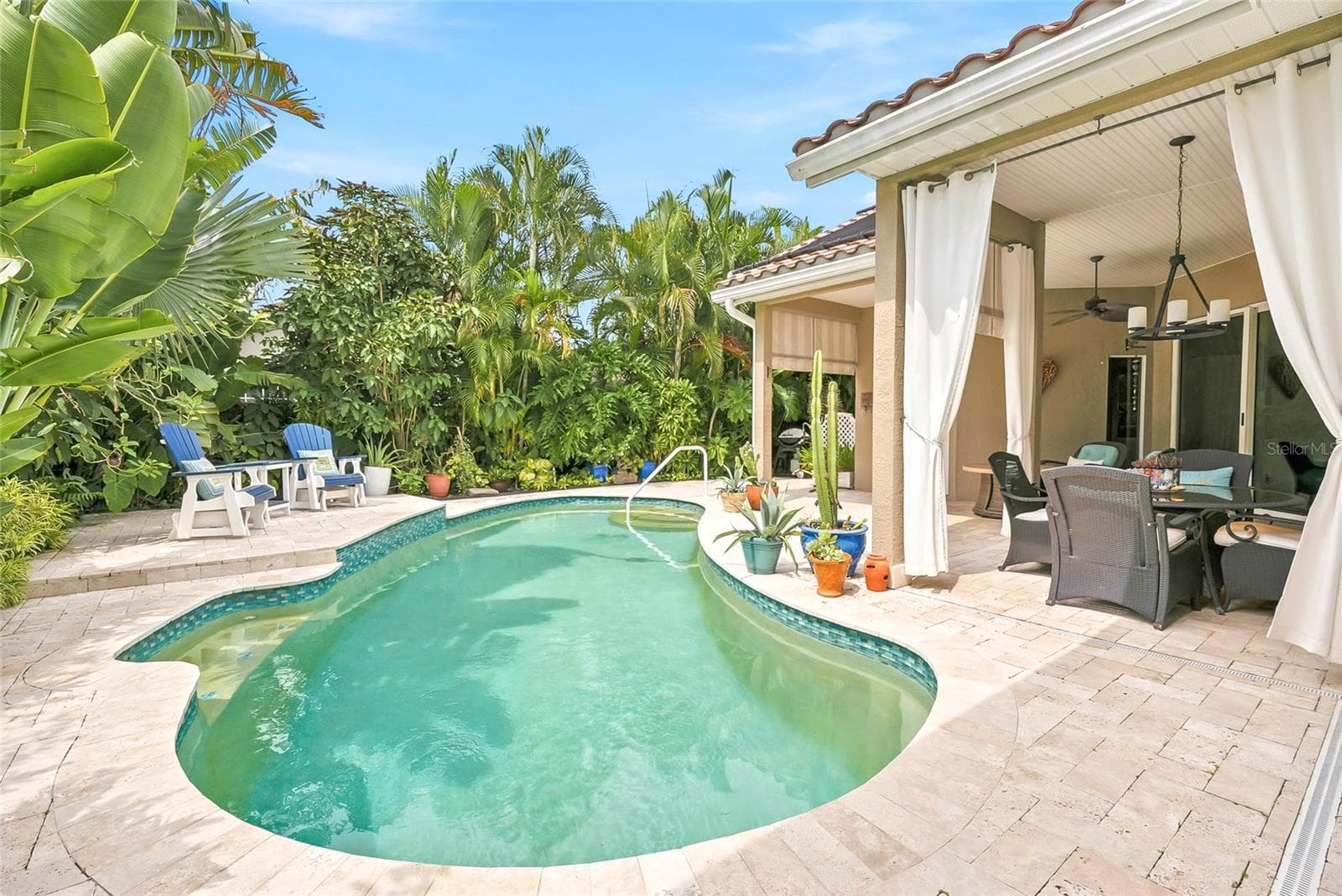 Solar-heated pool perfect for swimming laps or cooling off on the bench seat. - 4851 WINDMILL PALM TER NE, ST PETERSBURG