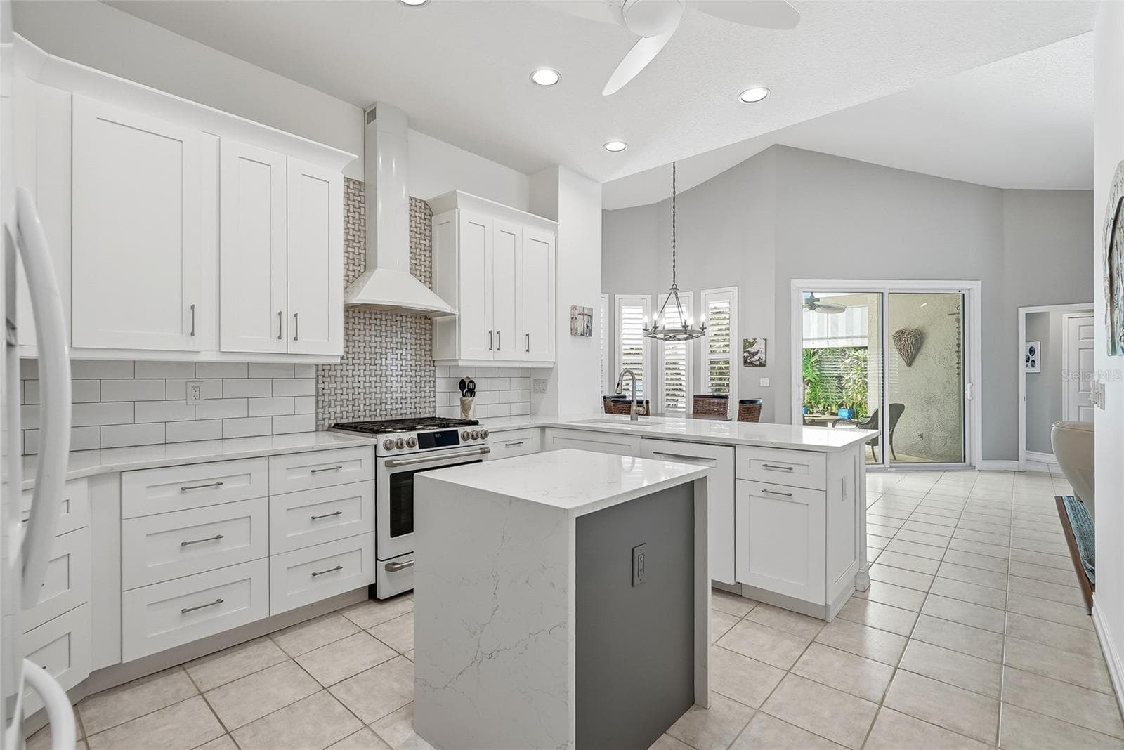 Absolute showstopper kitchen with electric-enhanced island, vented range hood, amazing cabinet and pantry space. - 4851 WINDMILL PALM TER NE, ST PETERSBURG