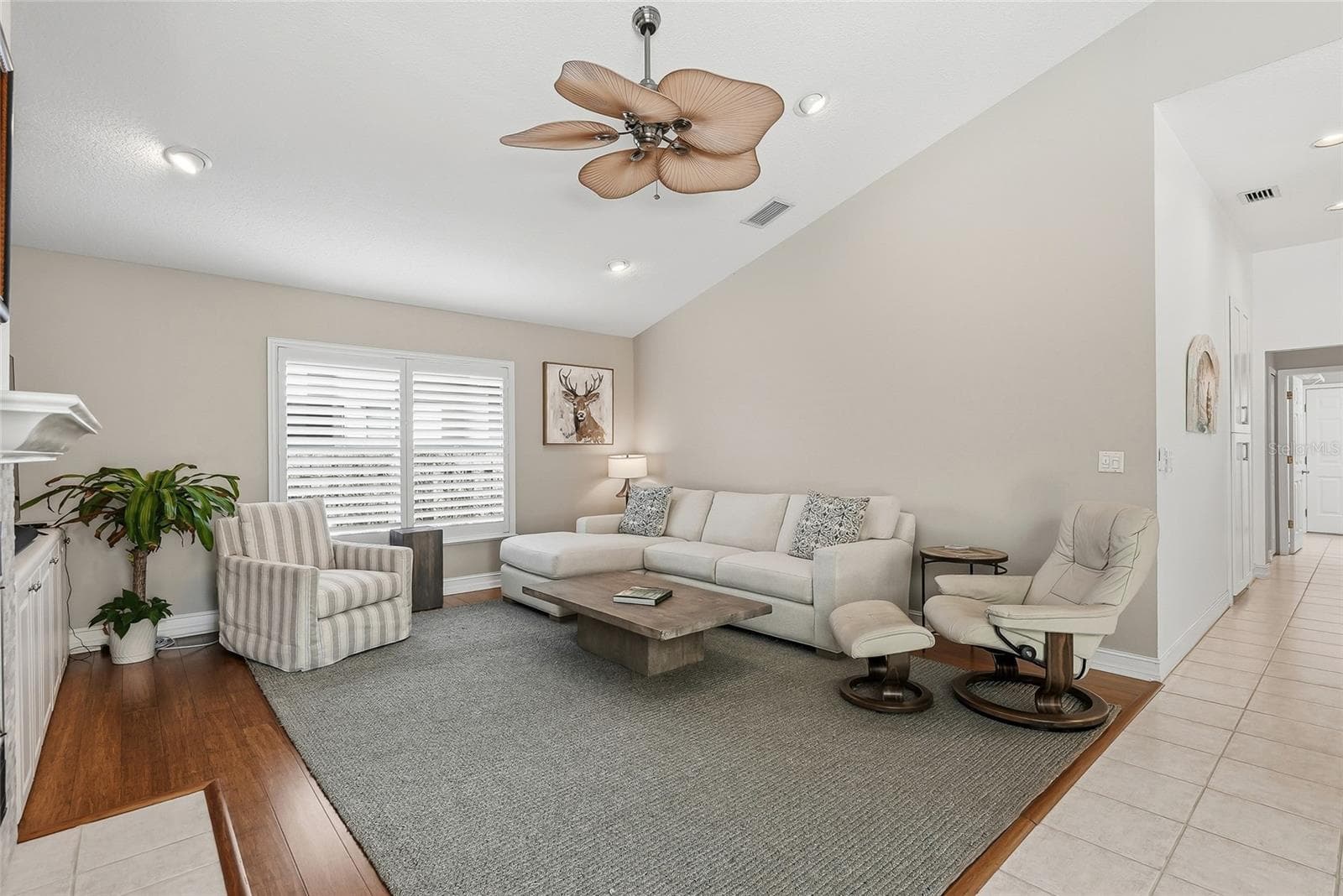 Large living room with media built ins and a wood-burning fireplace. - 4851 WINDMILL PALM TER NE, ST PETERSBURG