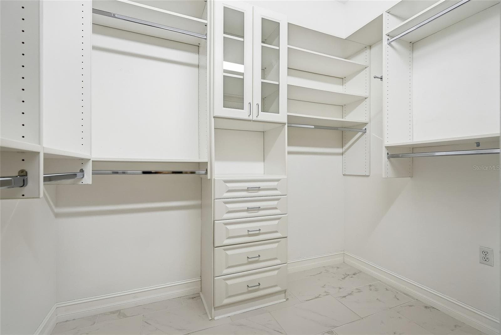 Wow! The primary walk-in closet is stunning with amazing custom shelving. - 4851 WINDMILL PALM TER NE, ST PETERSBURG