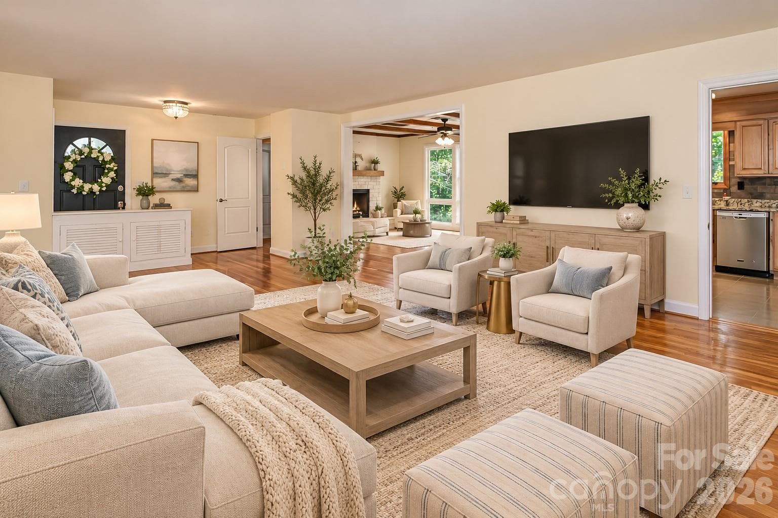 Spacious living area featuring an expansive open floor plan designed to accommodate a variety of furniture arrangements and décor styles.  Photo has been decorated by AI to show what it could look like furnished. - 7400 Oakwood Lane, Charlotte