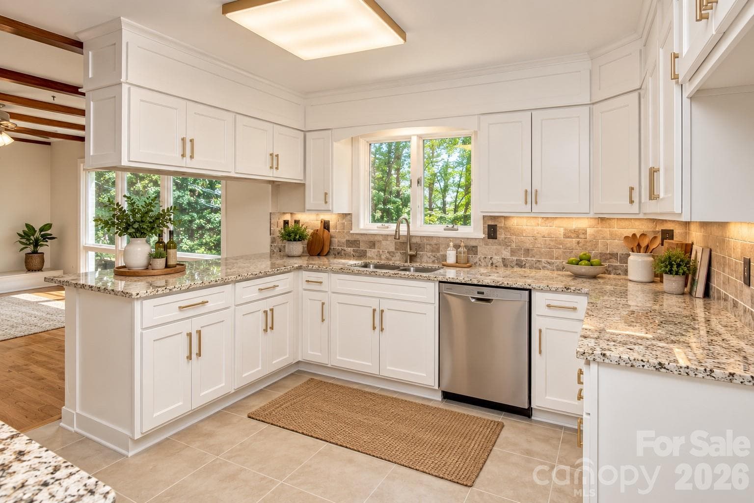 Modernized gourmet kitchen featuring crisp white cabinetry, updated hardware, and a bright, airy aesthetic. Virtual staging for illustrative purposes. - 7400 Oakwood Lane, Charlotte