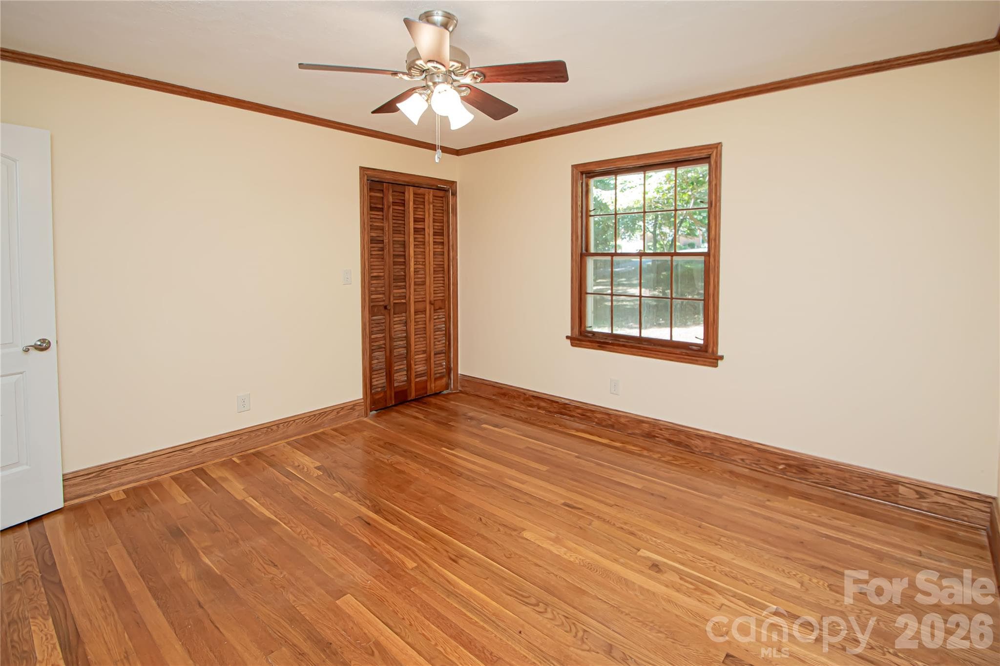 Bedroom # 2 has hardwood floors and ceiling fan. - 7400 Oakwood Lane, Charlotte