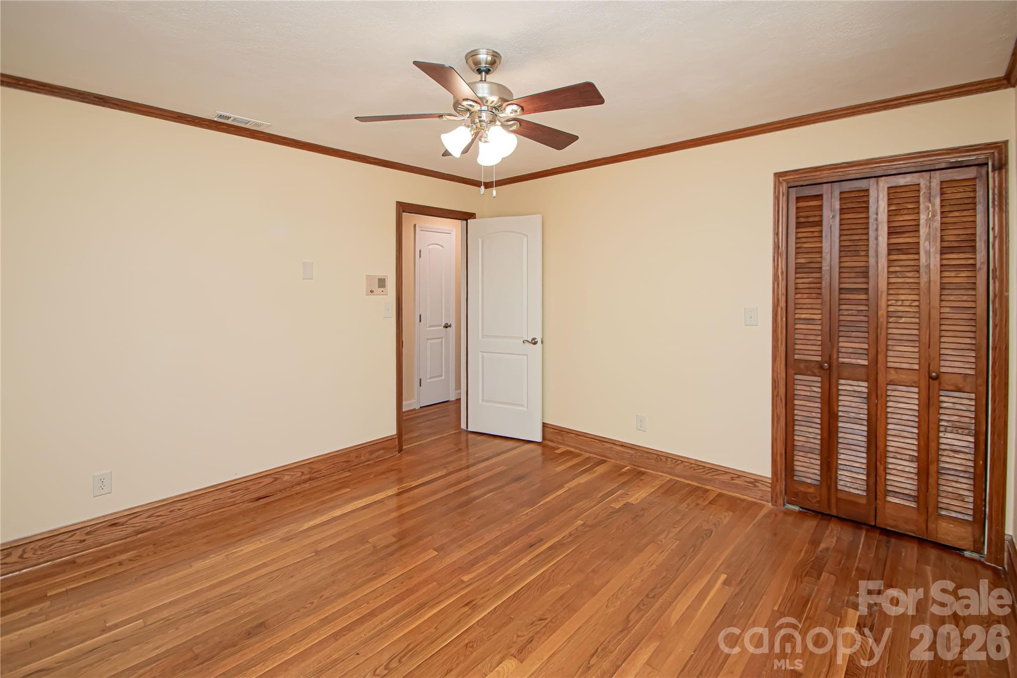 Bedroom # 2 has hardwood floors and ceiling fan. - 7400 Oakwood Lane, Charlotte