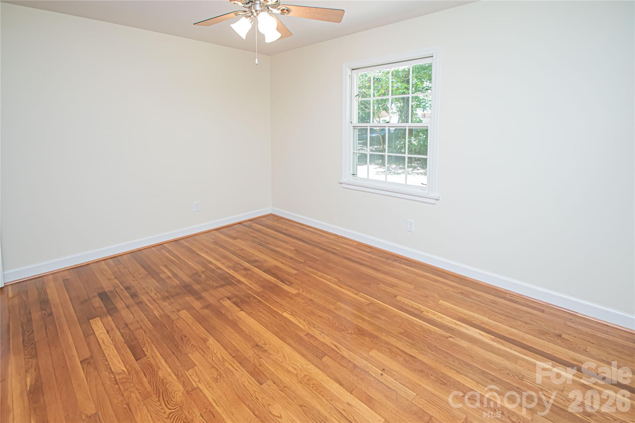 Bedroom # 3 has hardwood floors, ceiling fan and large windows that provide natural light. - 7400 Oakwood Lane, Charlotte