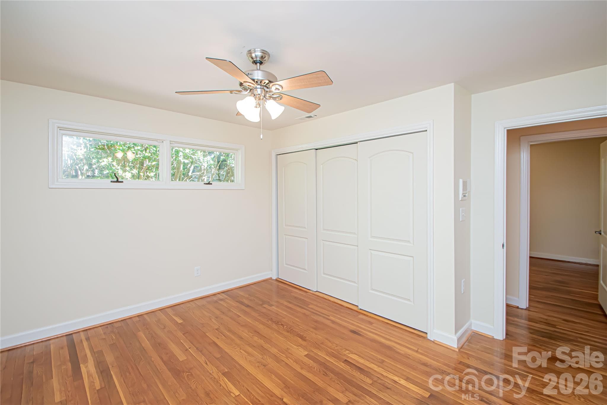 Bedroom # 3 has hardwood floors, ceiling fan and large windows that provide natural light. - 7400 Oakwood Lane, Charlotte