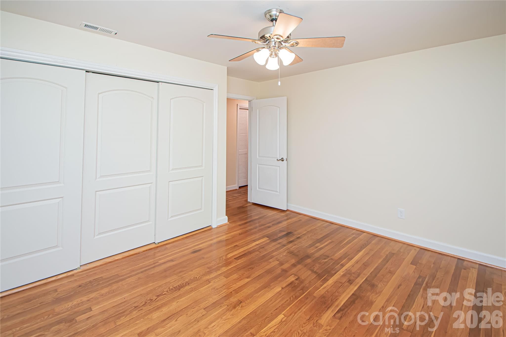 Bedroom # 3 has hardwood floors, ceiling fan and large windows that provide natural light. - 7400 Oakwood Lane, Charlotte