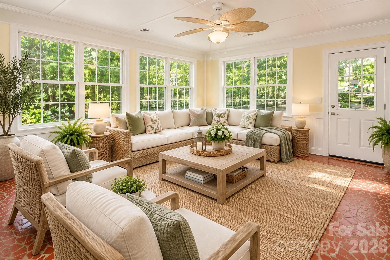 Spacious sunroom has windows all over that provide beautiful views of the lake.  Photo has been enhanced by AI to show placement of furniture. - 7400 Oakwood Lane, Charlotte