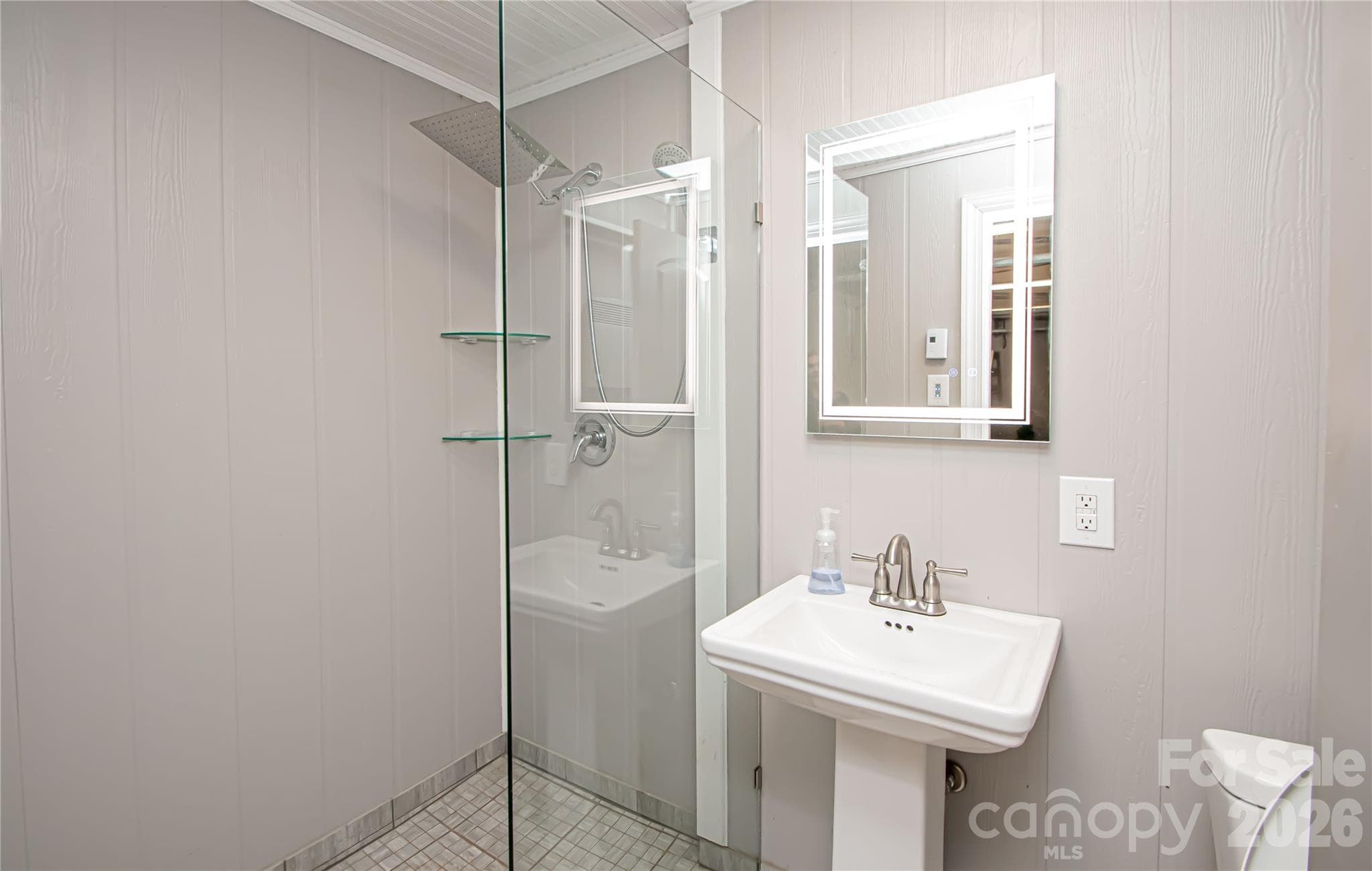 Basement bathroom conveniently located adjacent to the garage entrance. - 7400 Oakwood Lane, Charlotte