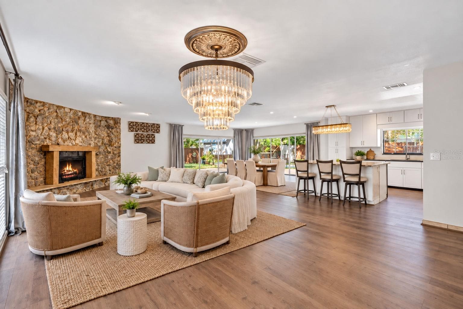 Virtually Staged. An open-concept layout is anchored by a striking floor-to-ceiling stone fireplace and wide plank wood-look flooring. - 3011 LAKE ELLEN DR, TAMPA