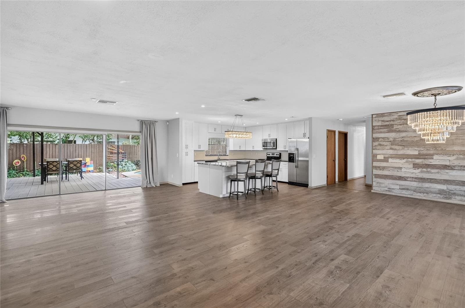 The open-concept living space flows seamlessly to the resort-style backyard, making it an entertainer's dream! - 3011 LAKE ELLEN DR, TAMPA
