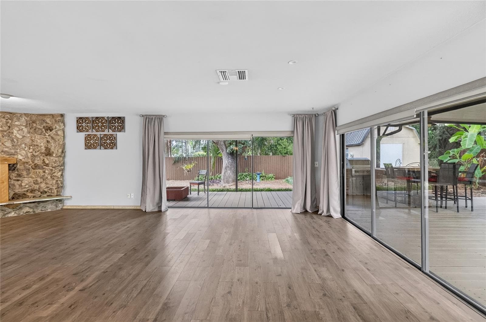 Expansive sliding glass doors fill the living and dining areas with natural light. - 3011 LAKE ELLEN DR, TAMPA