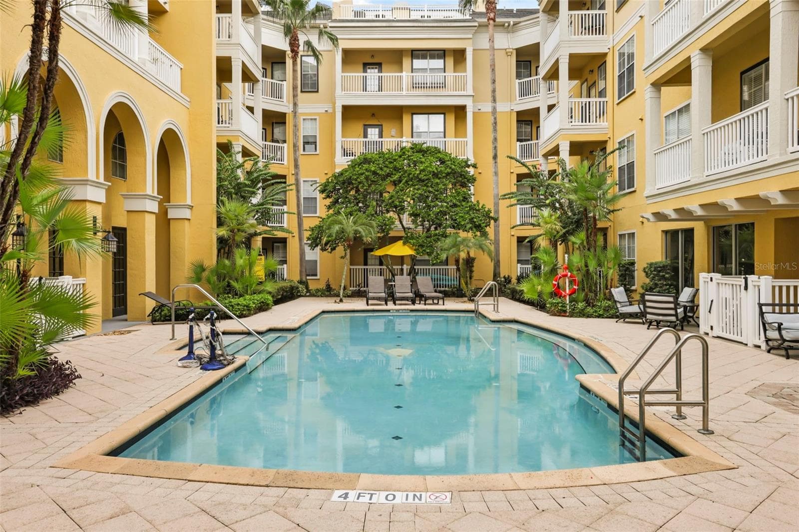 Resort-style pool framed by palms and beautiful arched architecture. - 860 N ORANGE AVE #323, ORLANDO