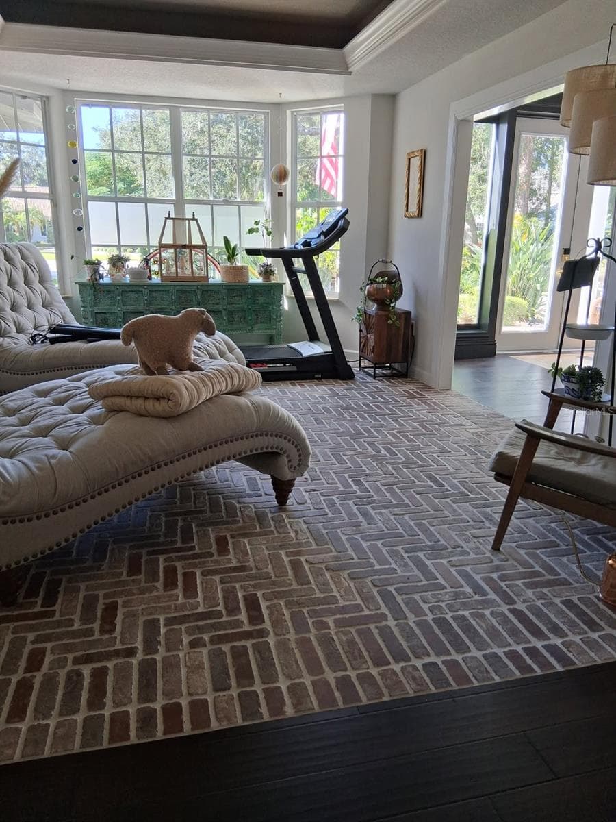 Formal Den was reimagined by owners into a Garden Room with Brick Floors. Open to the Living Room. Custom Molding & lighting in Ceiling - 3171 DICK WILSON DR, SARASOTA