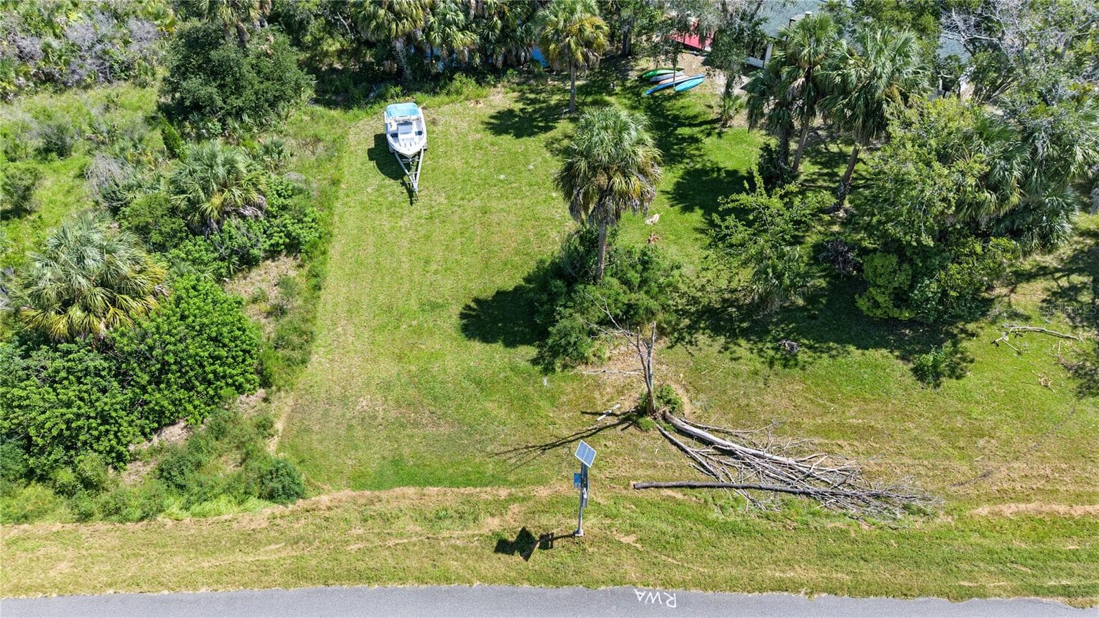 Elevated view highlighting the property's open space, mature trees, and surrounding greenery. - 10933 W FORT ISLAND TRL, CRYSTAL RIVER