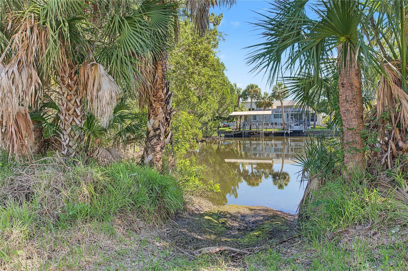 Natural vegetation frames peaceful views of the nearby waterway. - 10933 W FORT ISLAND TRL, CRYSTAL RIVER