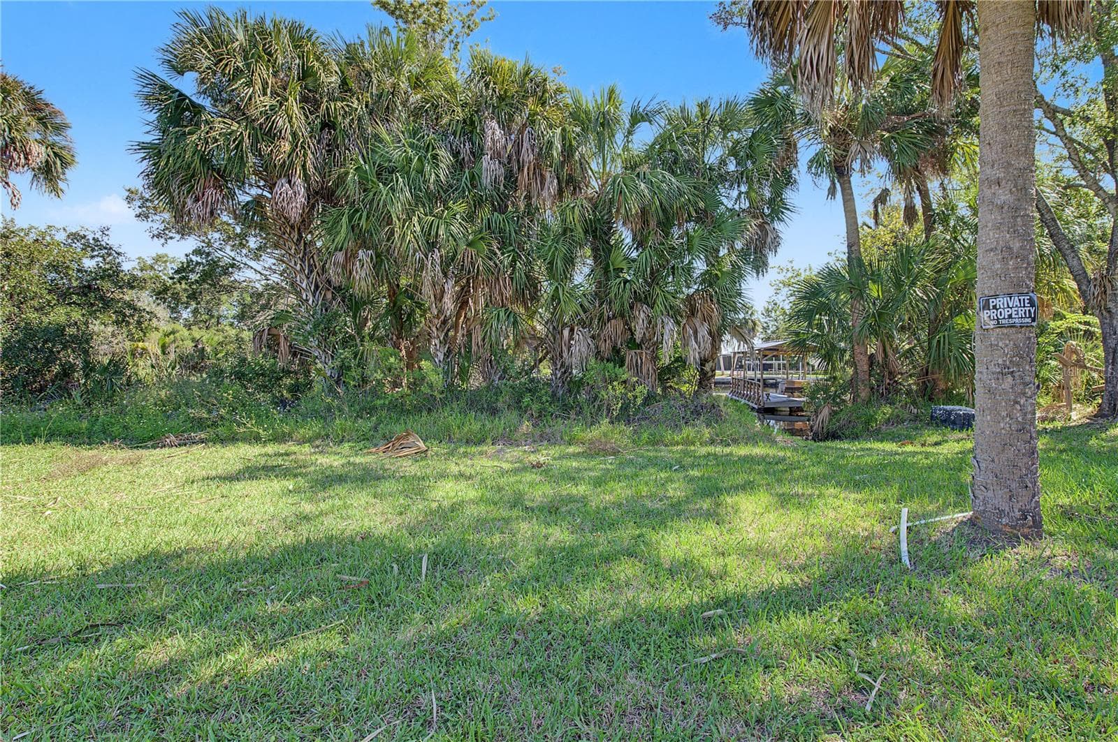 Sun-filled open space surrounded by mature trees and tropical Florida vegetation. - 10933 W FORT ISLAND TRL, CRYSTAL RIVER