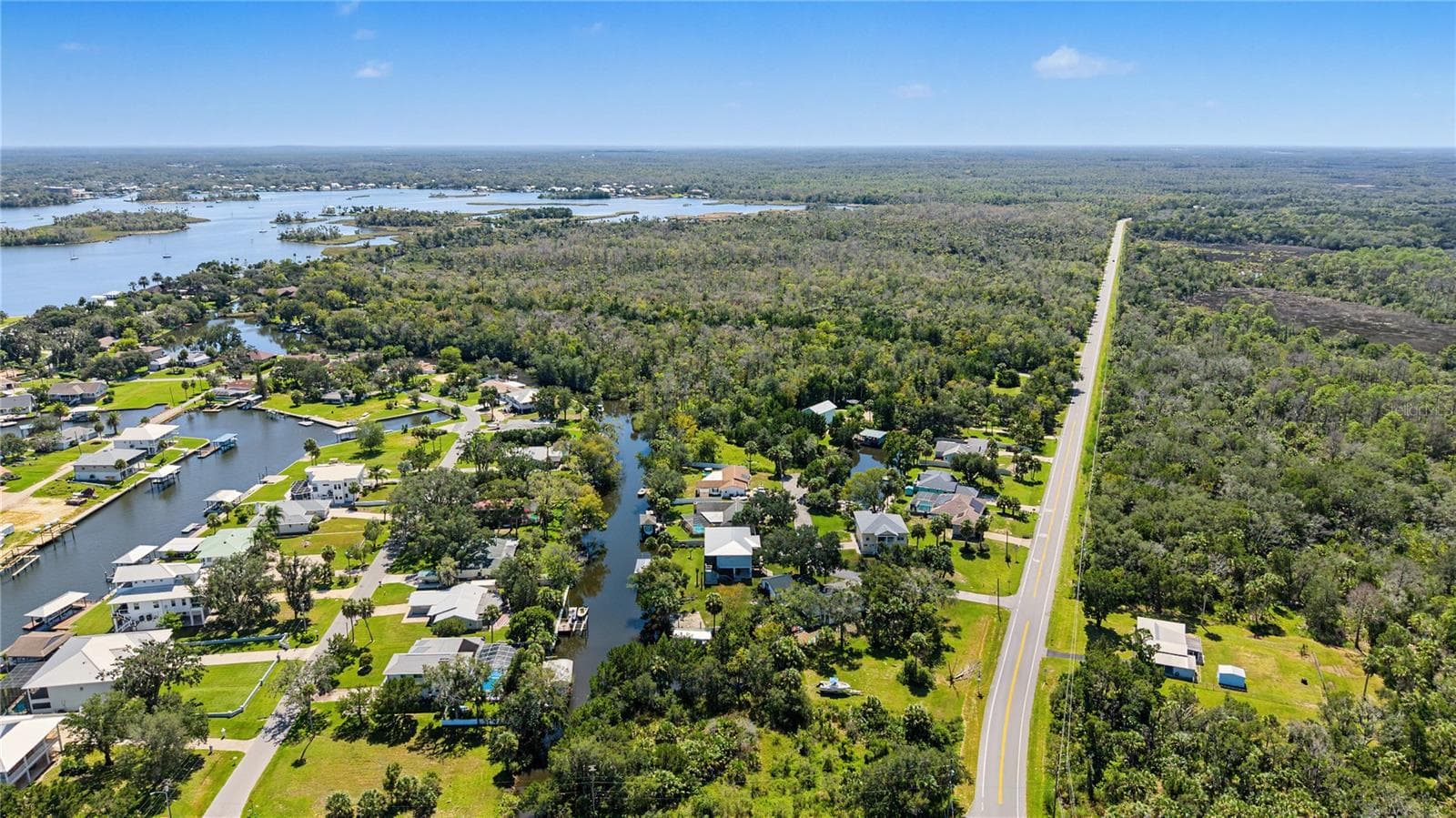 Sweeping aerial perspective highlighting the Fort Island area's coastal landscape, surrounding waterways, and natural beauty. - 10933 W FORT ISLAND TRL, CRYSTAL RIVER
