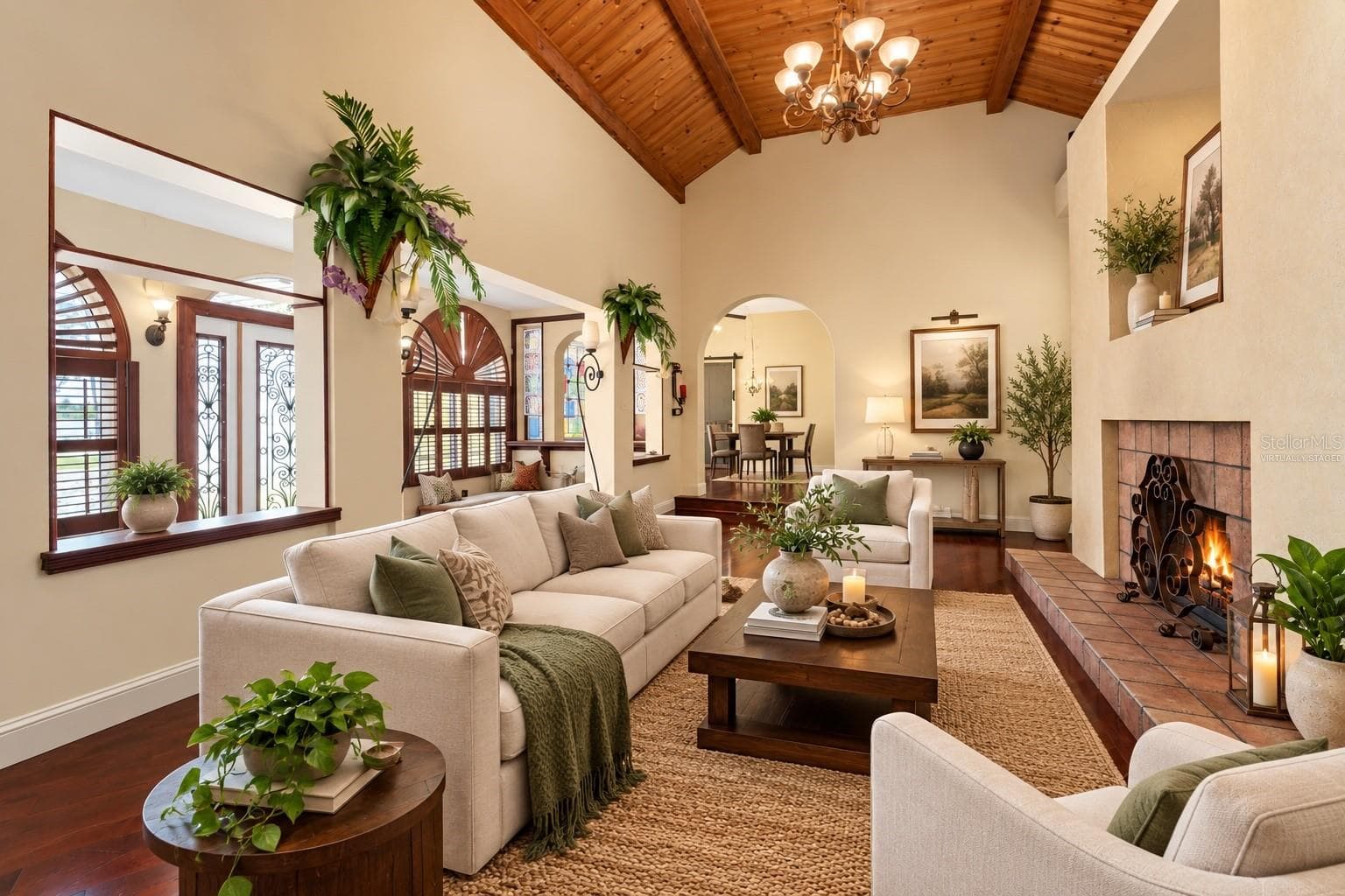 VIRTUALLY STAGED - MAIN HOUSE LIVING/WOOD FIREPLACE ROOM - 815 LAKE JESSIE DR, WINTER HAVEN