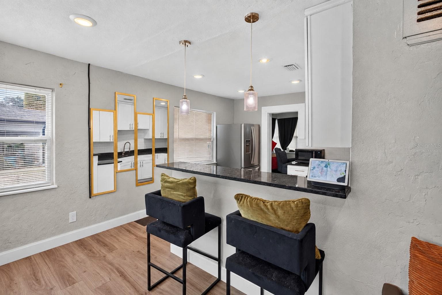 Virtually Staged. Personal Items digitally removed. Living room overlooking open kitchen with breakfast bar - 2452 17TH AVE S, ST PETERSBURG
