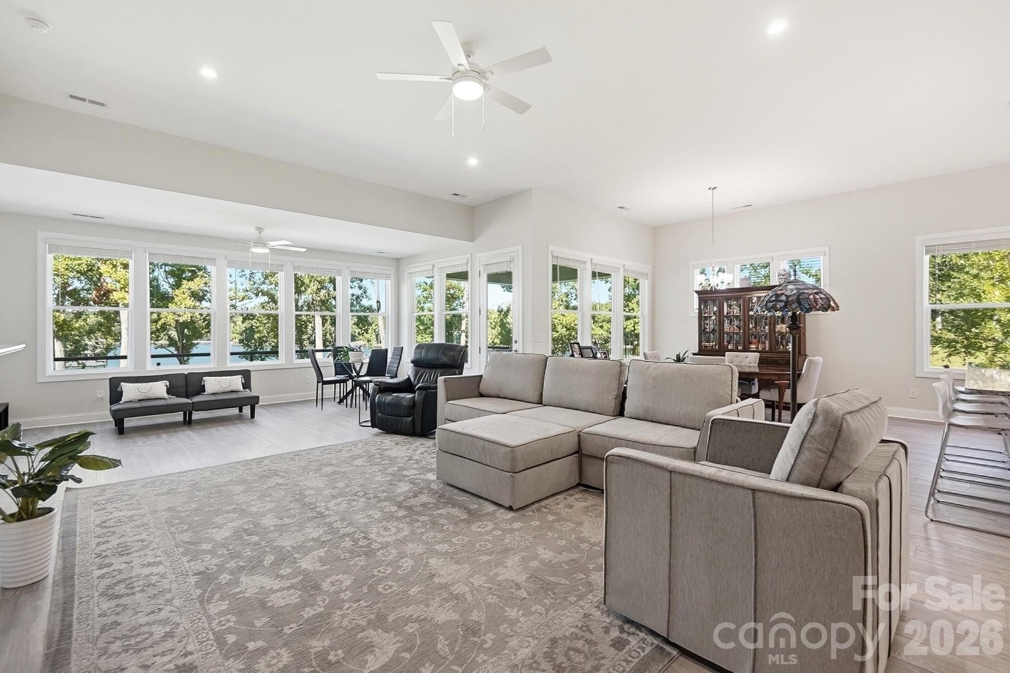 Framed by stunning lake views, the great room provides easy access to the outdoor living area, creating the perfect setting for relaxing and enjoying the lake - 8032 Longwaters Court, York