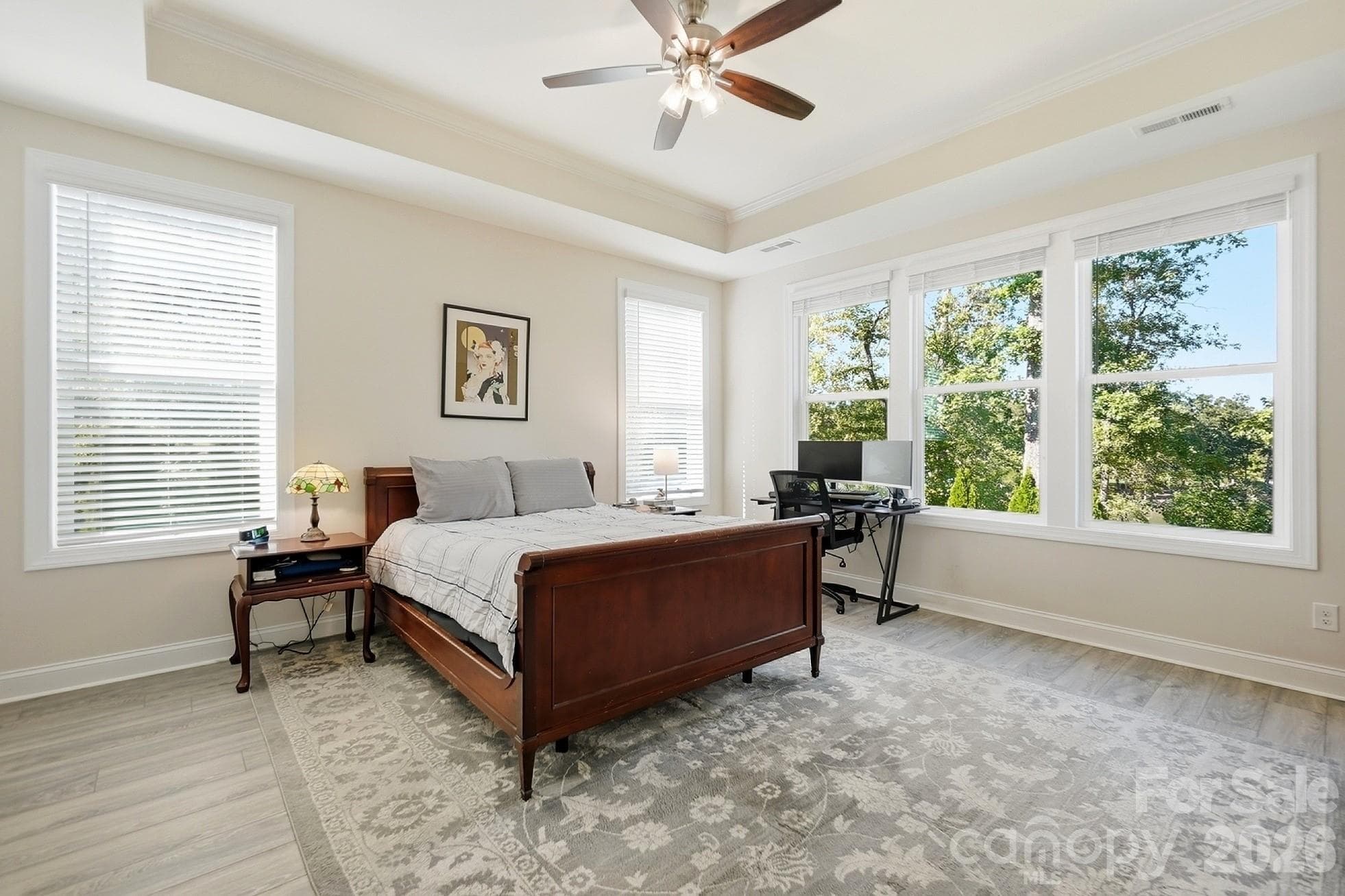 The private primary suite captures the stunning lake views and features a tray ceiling - 8032 Longwaters Court, York