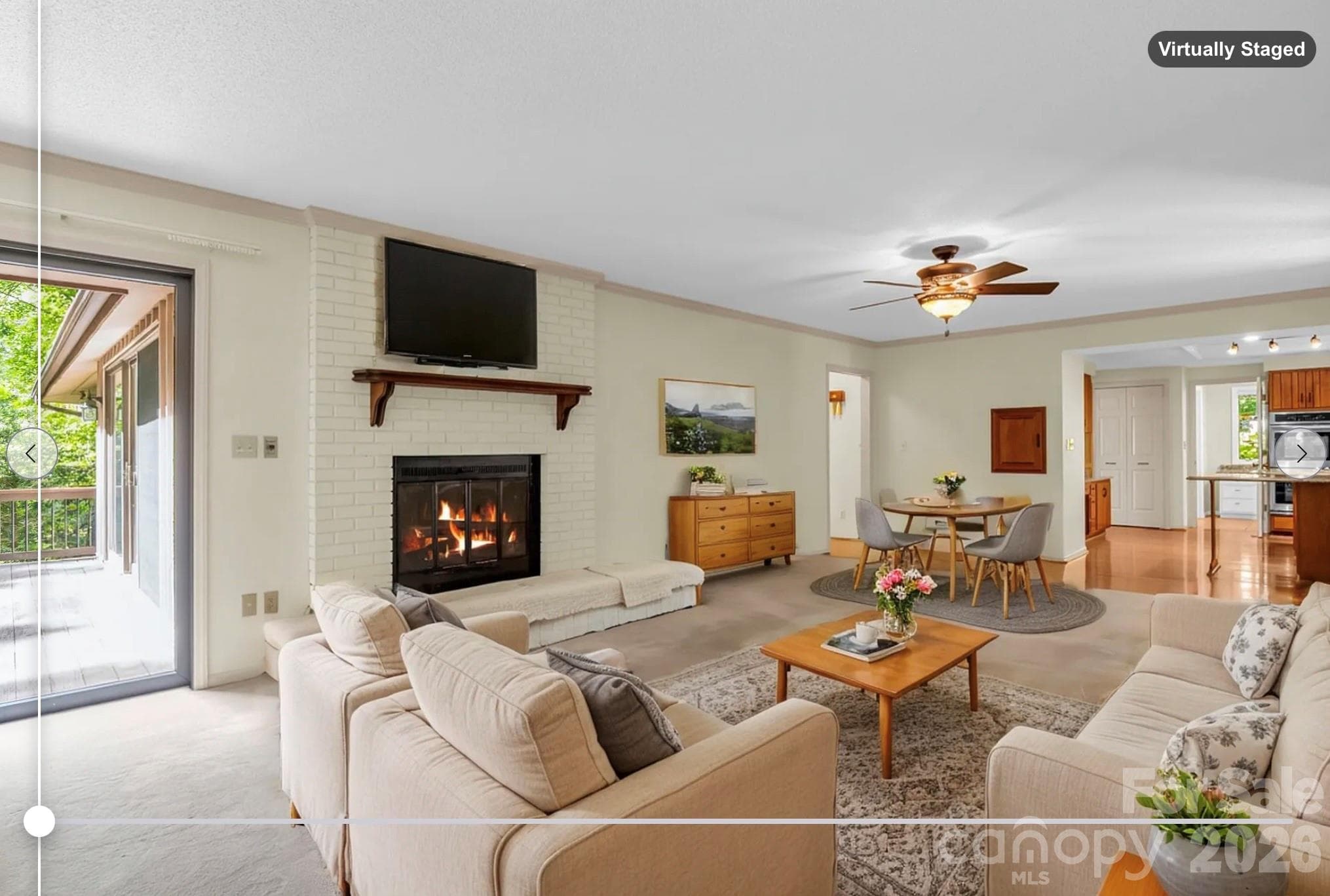 virtually staged - main level family room with wood burning fireplace (fire digitally added) - 115 Woodhaven Drive, Hendersonville