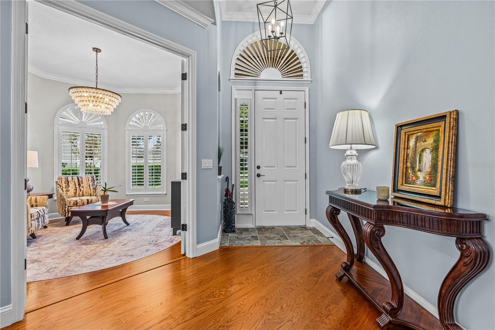 In the foyer looking toward the front door with the pretty arched transom window and into the front den/office through the open French doors - 520 SOTHEBY WAY, DEBARY