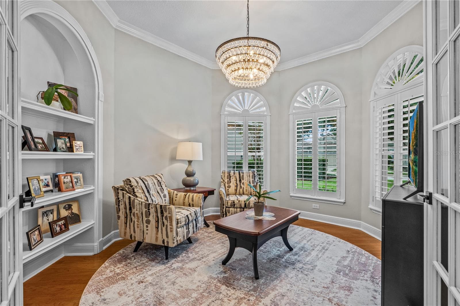 Currently used as a den, this would also make a great office with the built-in shelves; With all the windows, it's always light and bright - 520 SOTHEBY WAY, DEBARY