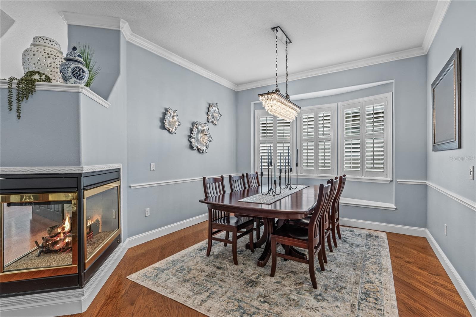 Dining room with decorative chair rail and window seat (behind the table); The fireplace is natural gas and adds warmth & ambiance - 520 SOTHEBY WAY, DEBARY