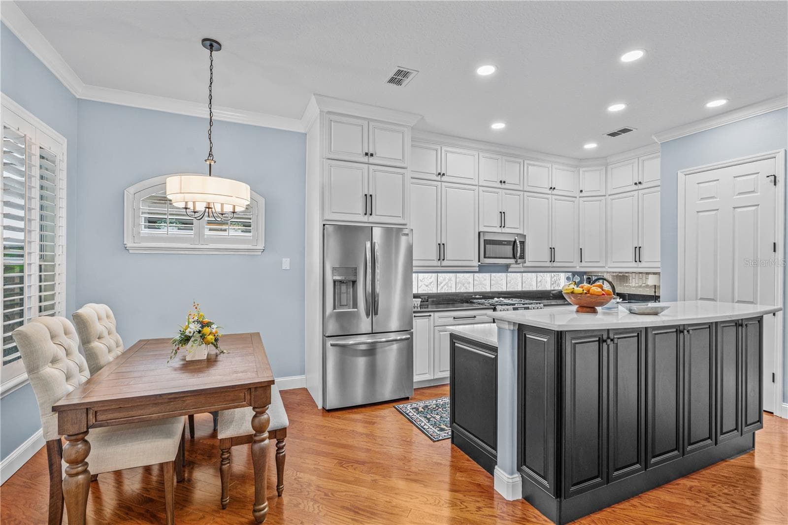 The renovated kitchen offers tons of storage-- there are even cabinets under the breakfast bar! - 520 SOTHEBY WAY, DEBARY