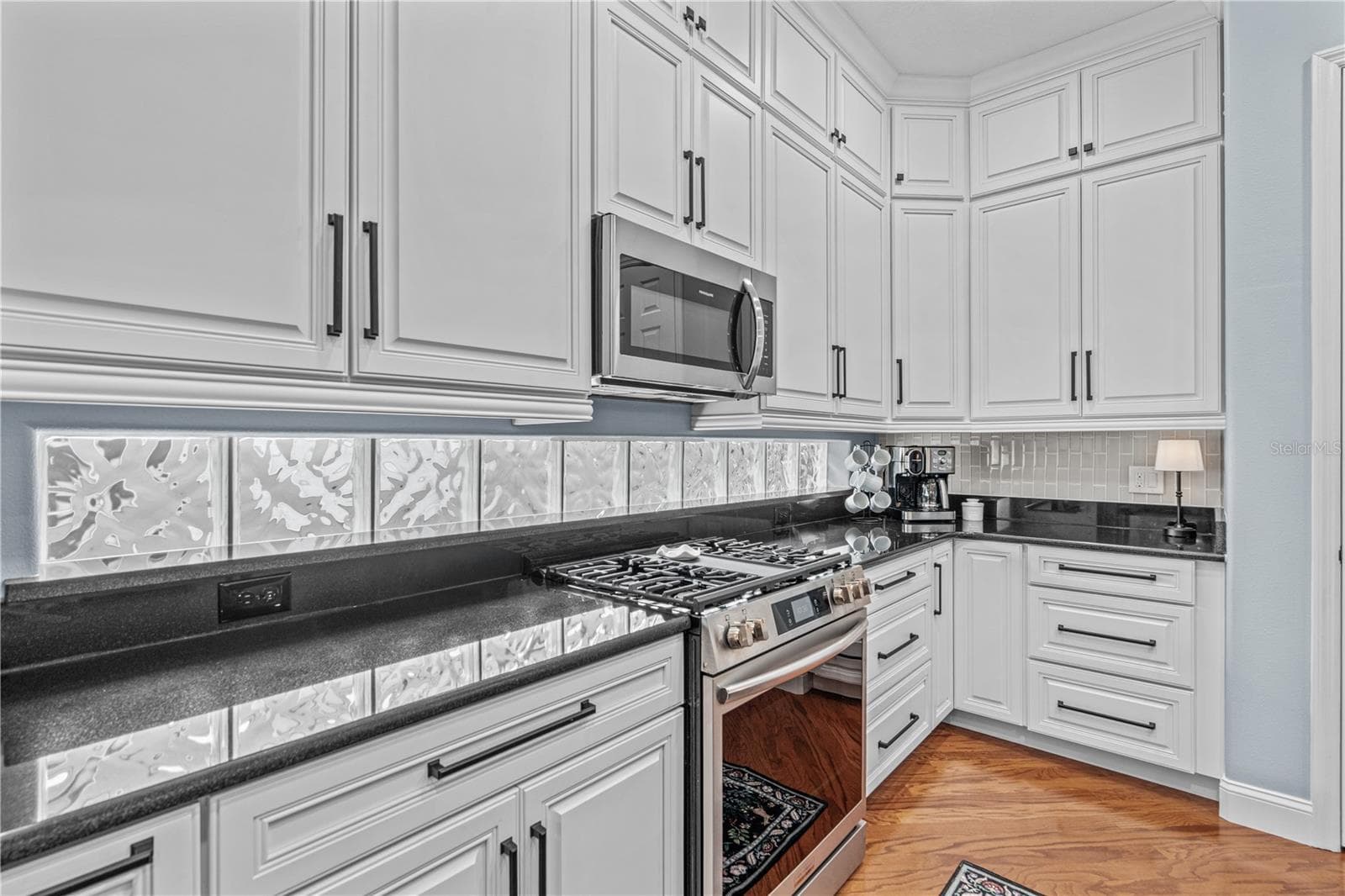Granite on the perimeter counters with the glass block windows providing even more natural light; And check out all those drawers! - 520 SOTHEBY WAY, DEBARY
