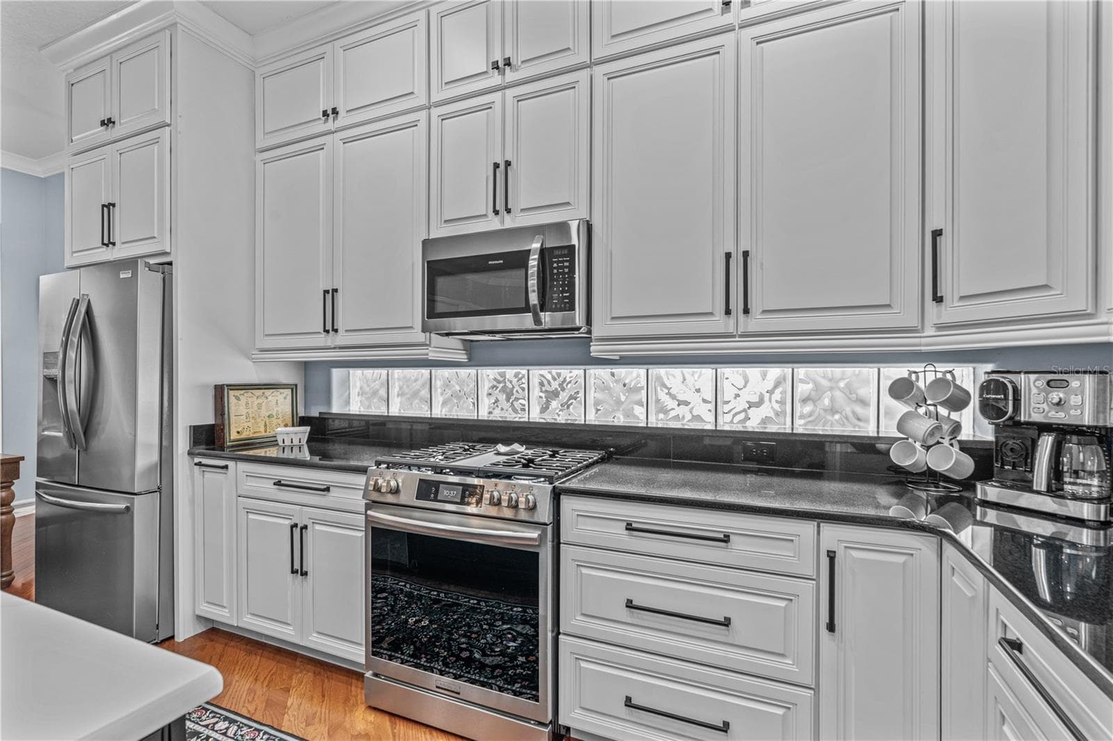 All the cabinets in the home are solid wood and custom made with soft close doors and drawers. The extra high cabinets take advantage of every inch of those 10ft ceilings and are great for storing seasonal items - 520 SOTHEBY WAY, DEBARY