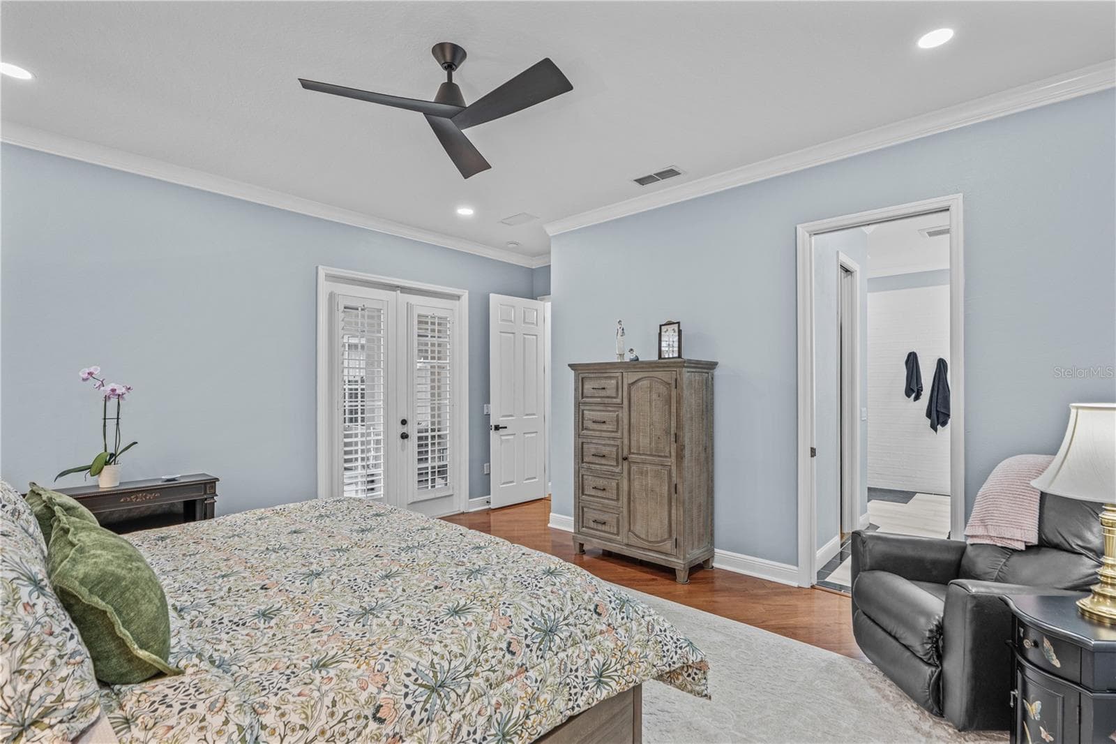Looking toward the entrance to the primary bedroom-- and showing the French doors to the lanai - 520 SOTHEBY WAY, DEBARY