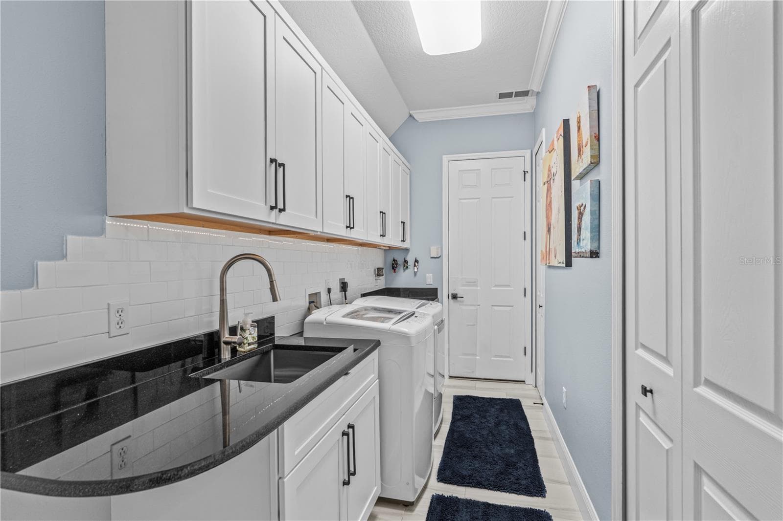 Renovated laundry room with tons more storage and granite counters; The "utility" sink-- which seems anything but utilitarian-- is stainless steel and extra deep - 520 SOTHEBY WAY, DEBARY