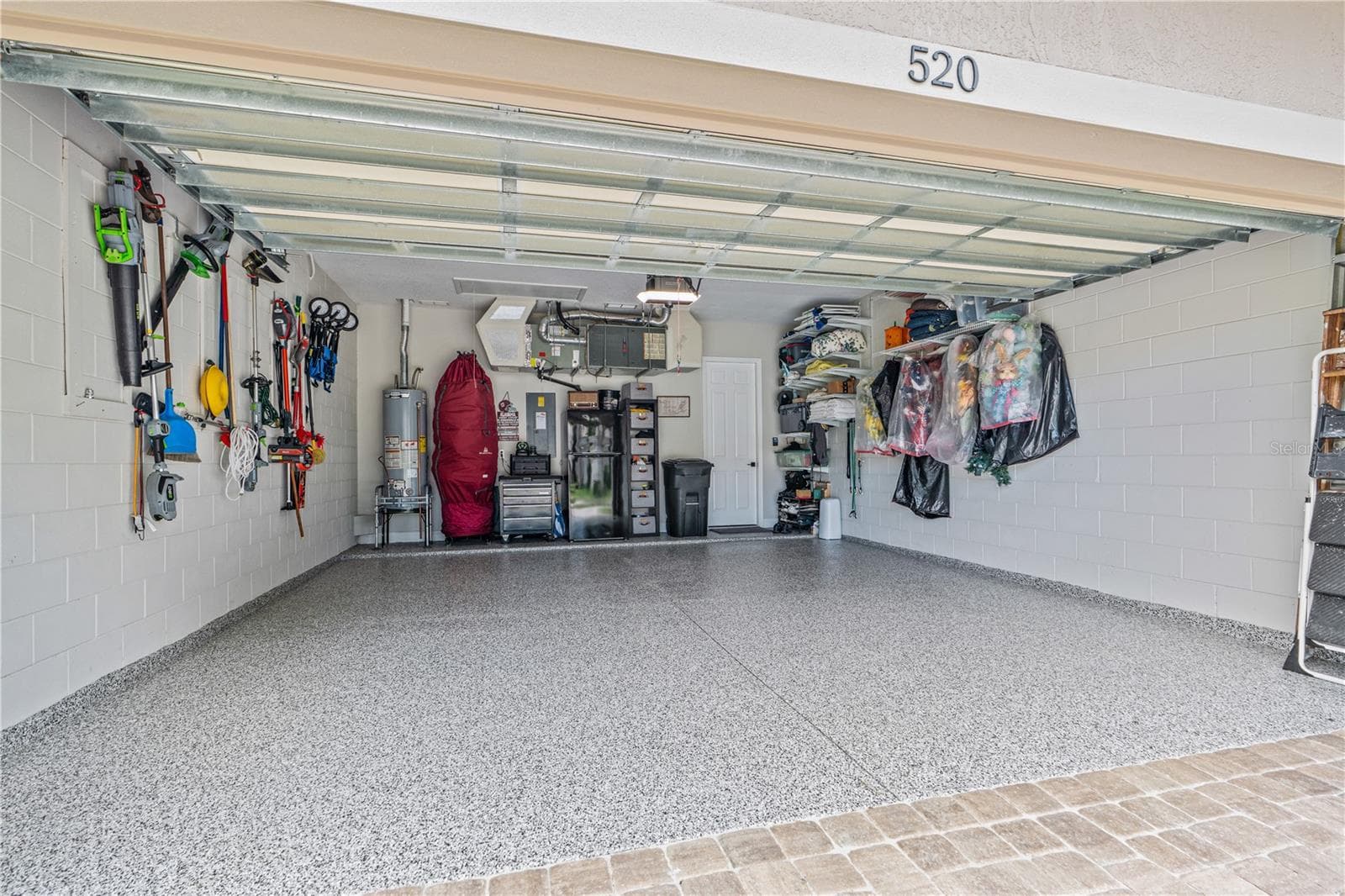 Epoxy-coated garage floor is immaculate; The "myQ" wifi-enabled garage door opener & entry pad with integrated camera (not shown in this picture) convey - 520 SOTHEBY WAY, DEBARY