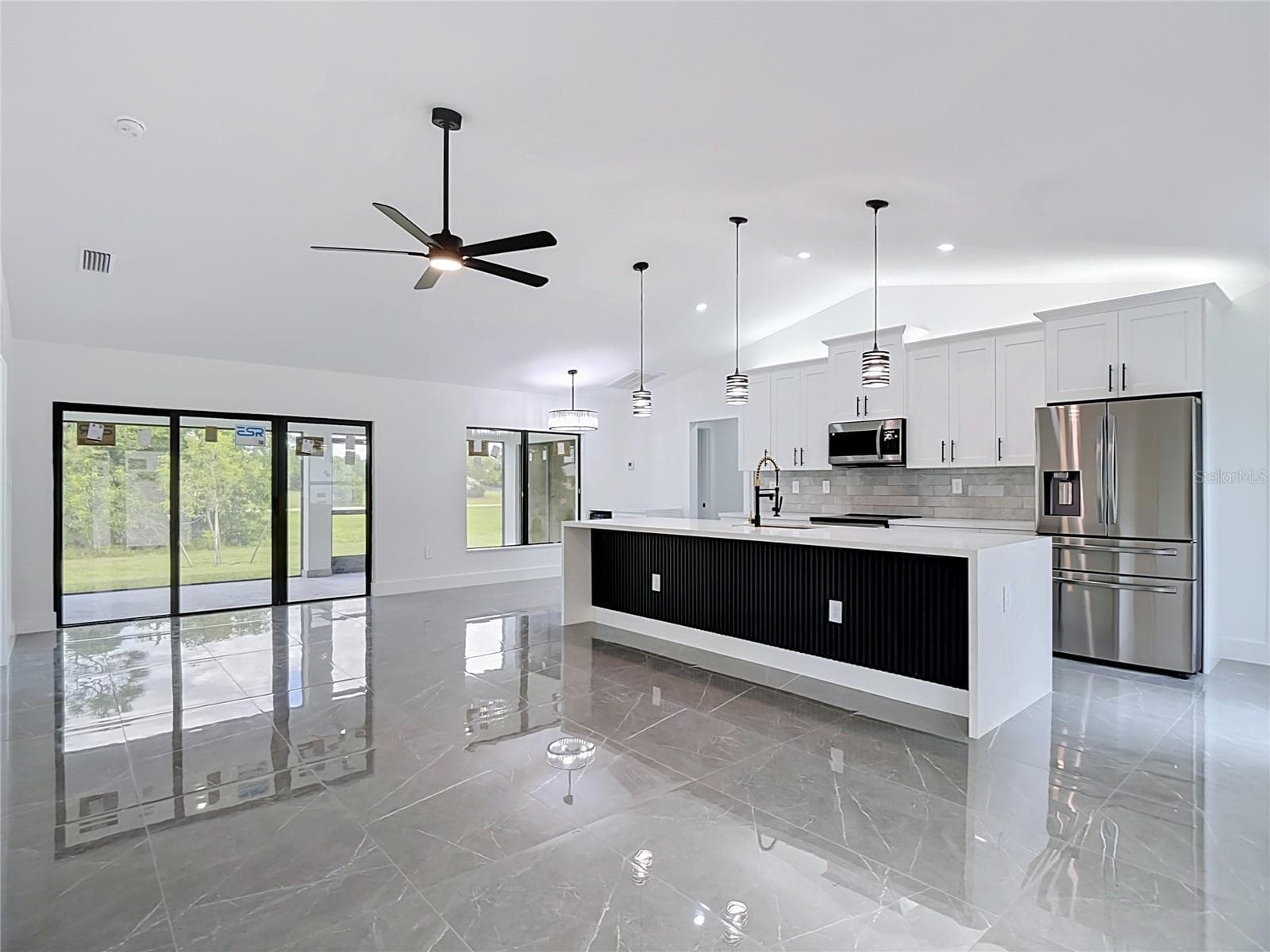 Another view of the open floor plan including the living room, kitchen & dining areas - 3613 NW 47TH LN, CAPE CORAL