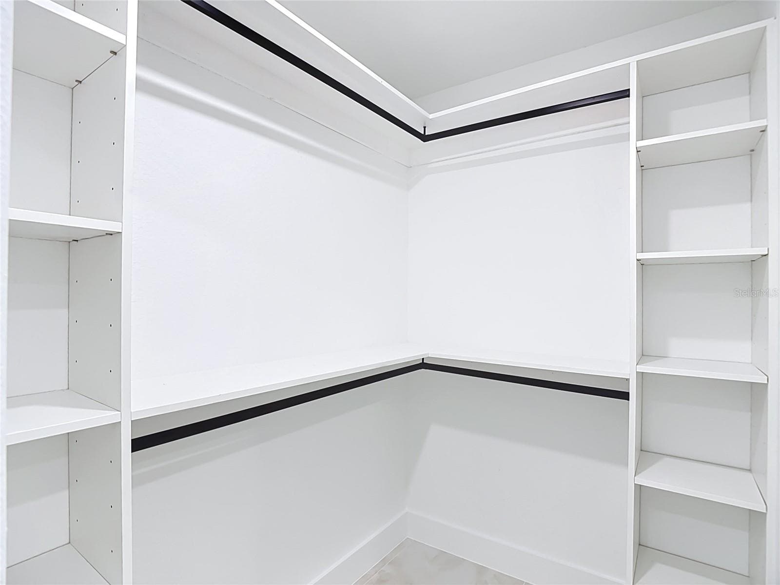 primary walk in closet with lots of shelving - 3613 NW 47TH LN, CAPE CORAL