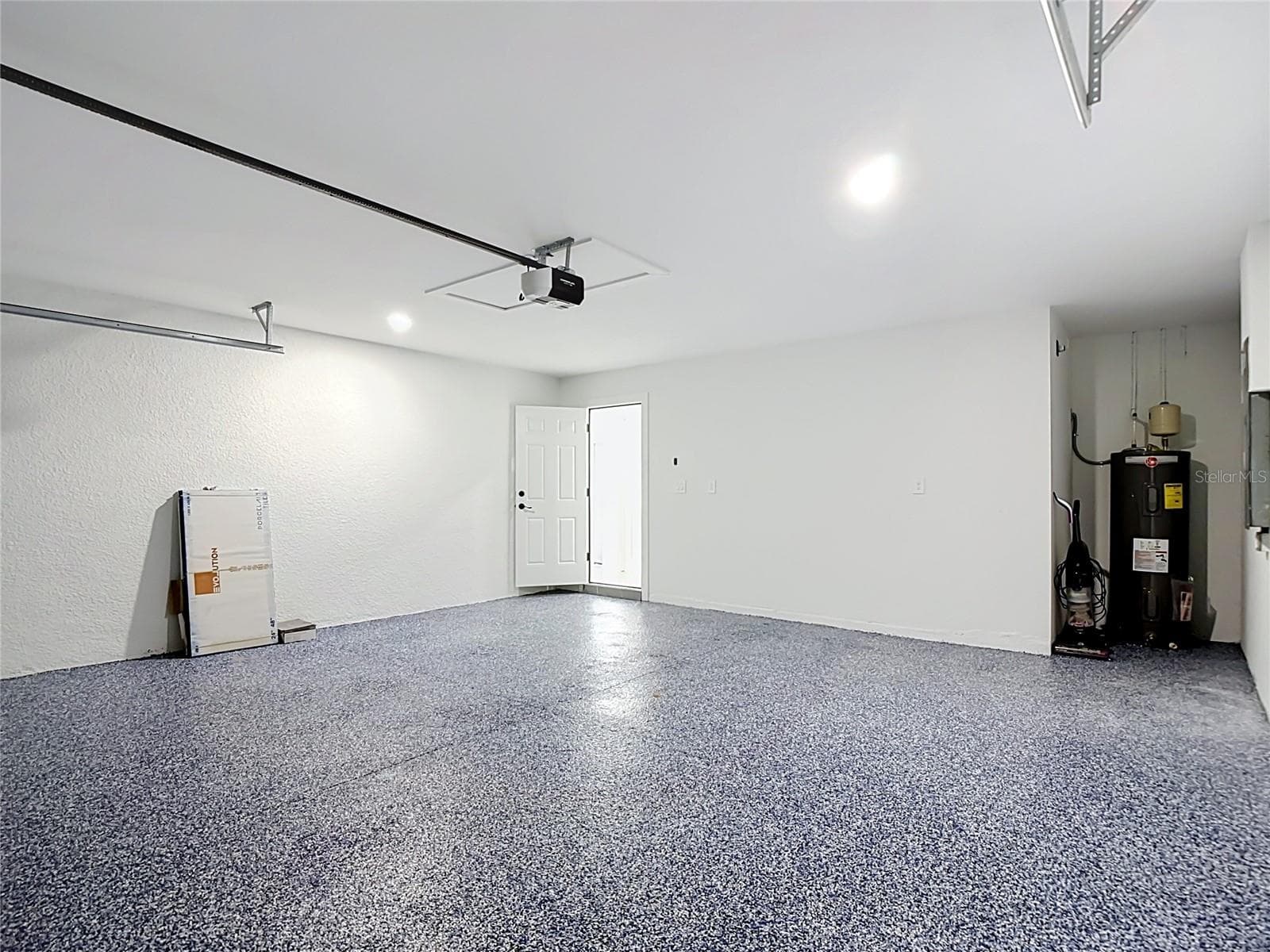 View of garage with Electric Door Opener & view of 50 gallon water tank - 3613 NW 47TH LN, CAPE CORAL