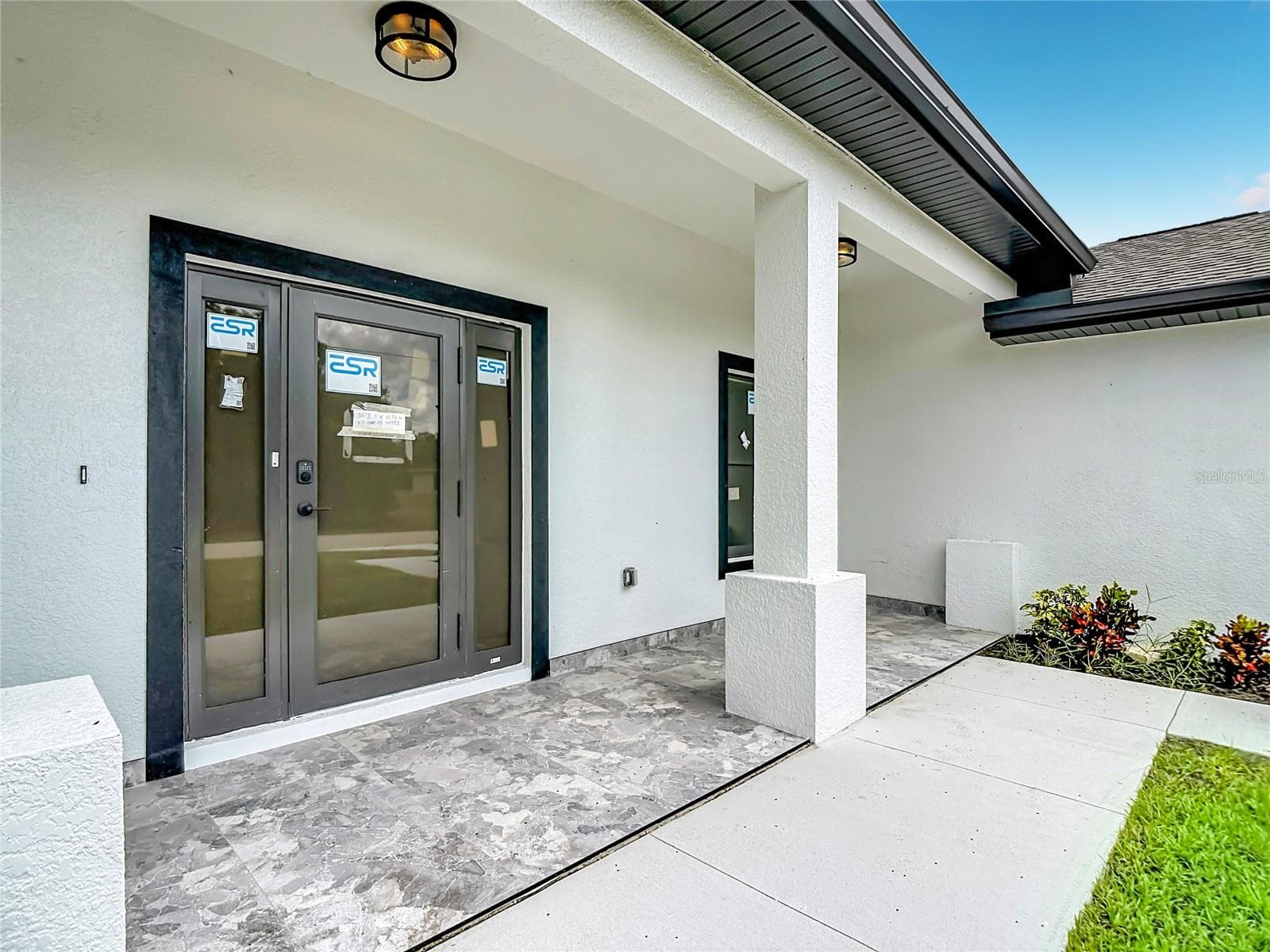 View of welcoming porch & front door - 3613 NW 47TH LN, CAPE CORAL