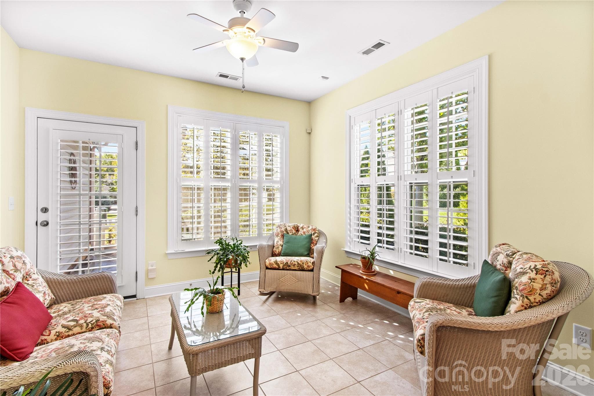 Bright sunroom provides extra year-round living space — perfect for a morning coffee or gathering with friends. - 18114 Ebenezer Drive, Cornelius