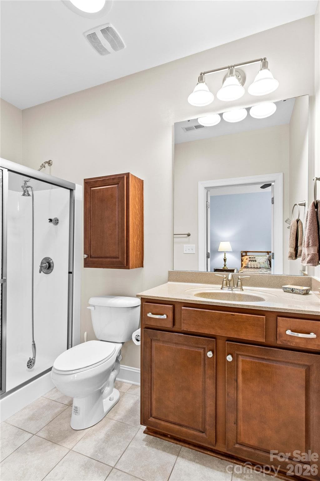 Primary bathroom with walk-in shower and gentleman's height vanity for comfort. - 18114 Ebenezer Drive, Cornelius