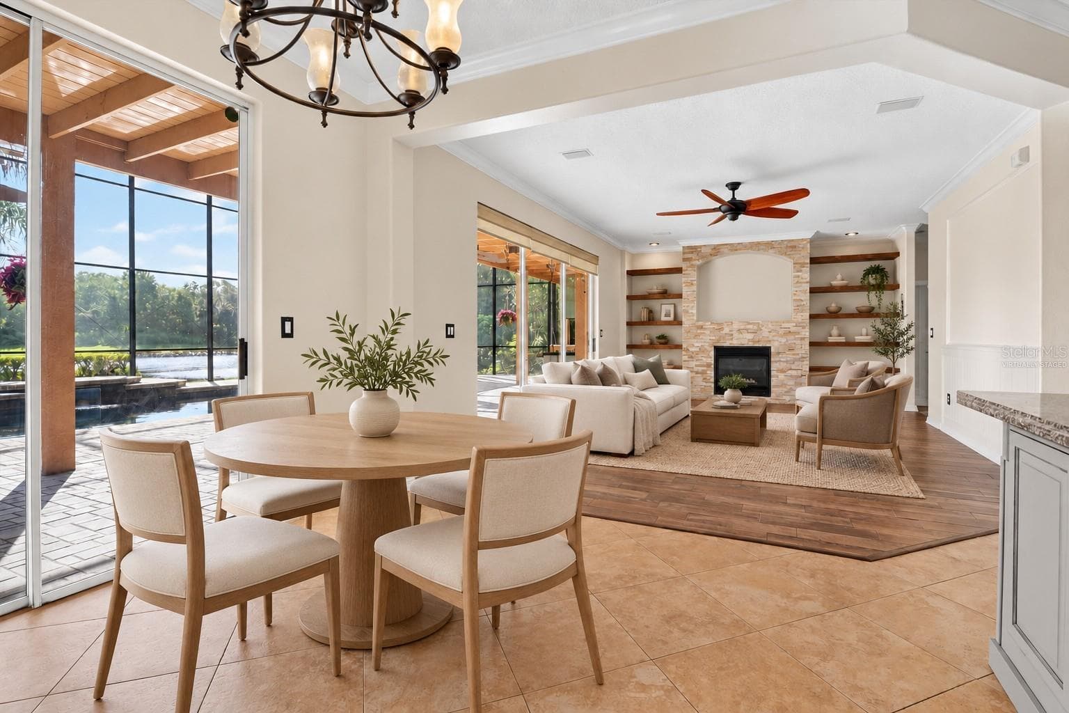 Virtually staged: Living and dining spaces opening toward the screened outdoor area. - 2109 WEMBLEY PL, OVIEDO