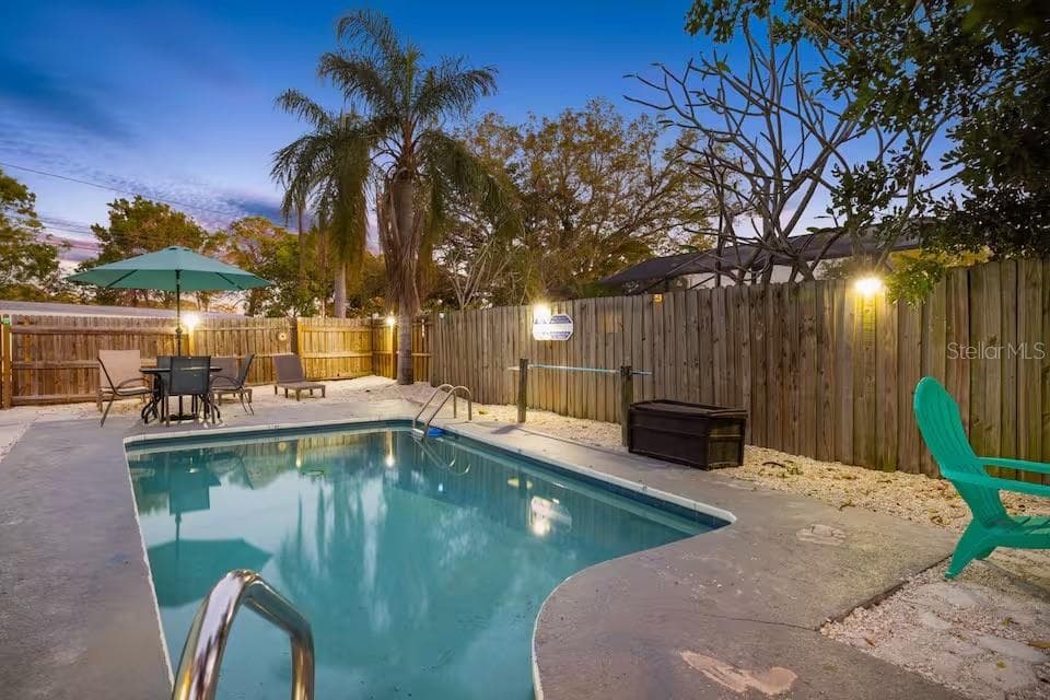 The private HEATED POOL takes center stage in this fully fenced backyard, with plenty of room to relax, dine, and enjoy Florida evenings outdoors. - 201 SOUTH ST, PALM HARBOR