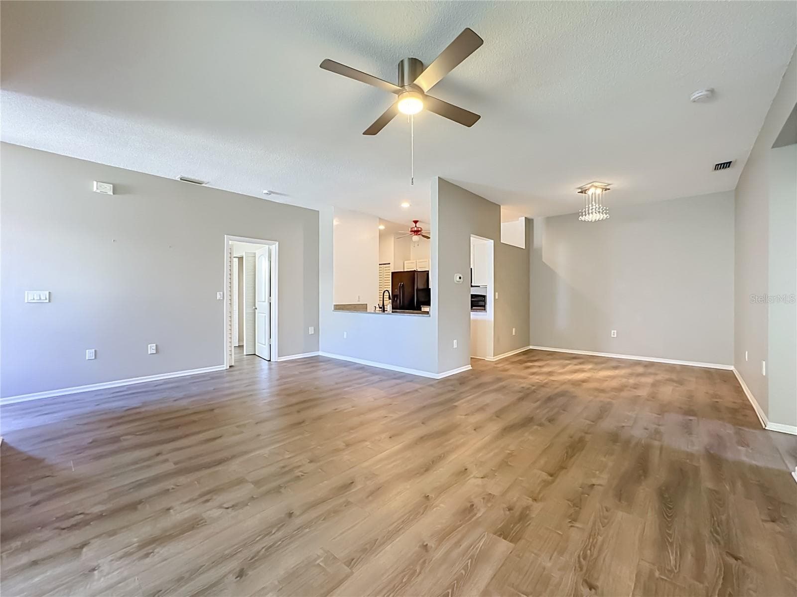 Great room and view into the dining room. - 3308 60TH AVE W, BRADENTON
