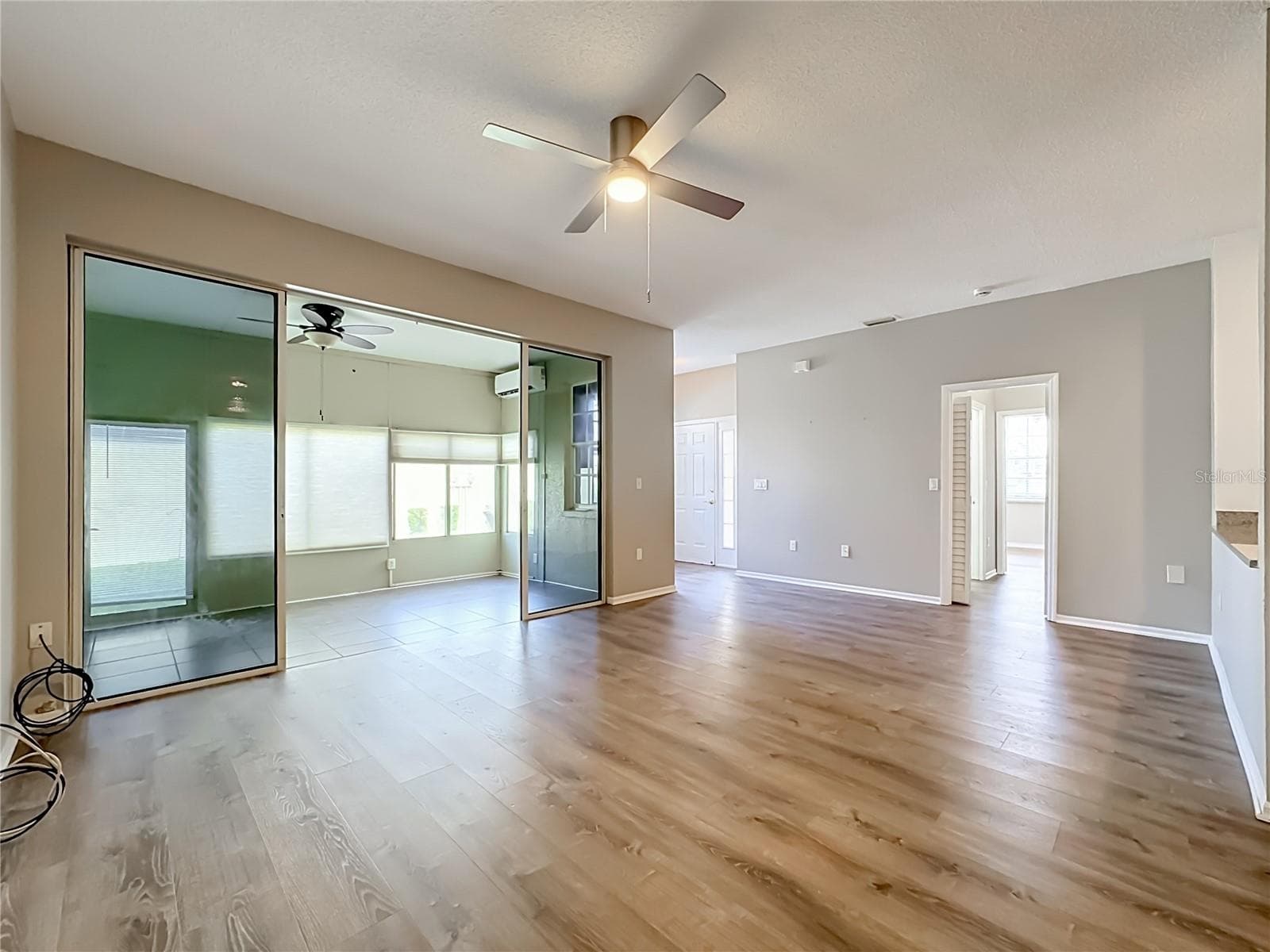 Great room with sliding door to the separately air conditioned large (280 sq. ft.) Florida room. - 3308 60TH AVE W, BRADENTON